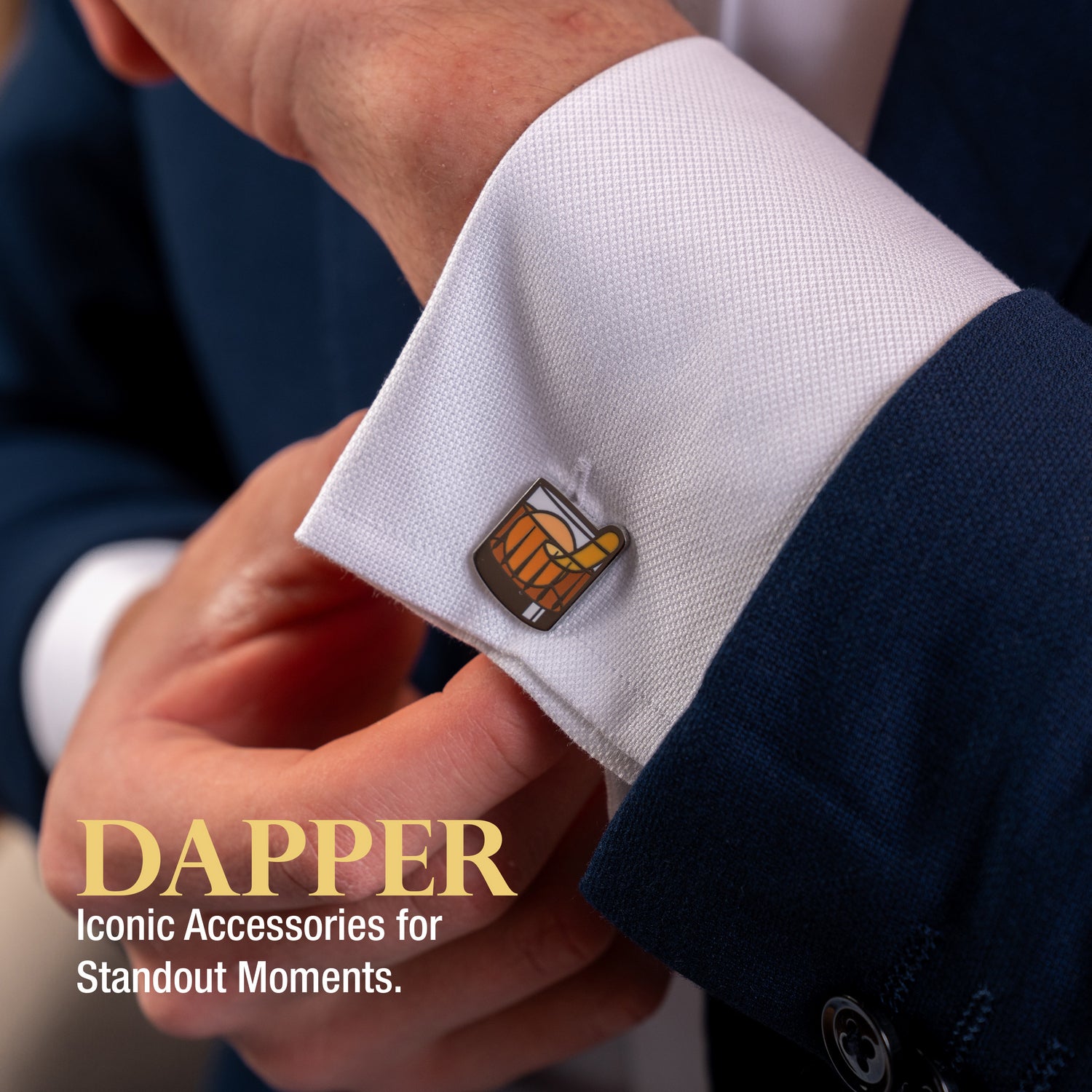 Old Fashioned cocktail cuff links being adjusted on a man's white shirt and suit.